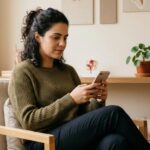 Mulher observando um aplicativo de acompanhamento de ciclo menstrual em tablet ou smartphone no consultório ginecológico.